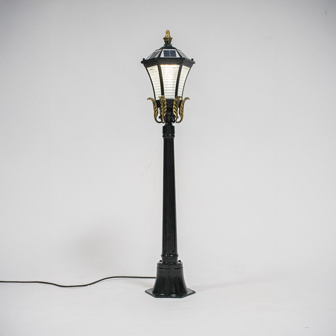 Vintage black outdoor garden light with warm glowing panels for elegant exterior decor styling use.