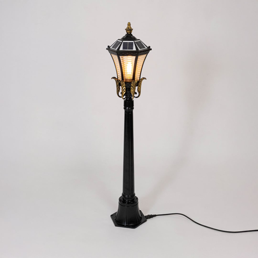 Black metal outdoor lantern post light with classic glass design for elegant exterior lighting decor placement.