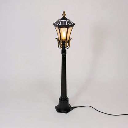 Black metal outdoor lantern post light with classic glass design for elegant exterior lighting decor placement.
