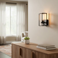 Modern black metal wall light with warm glow for stylish bedroom and contemporary home decor spaces.

