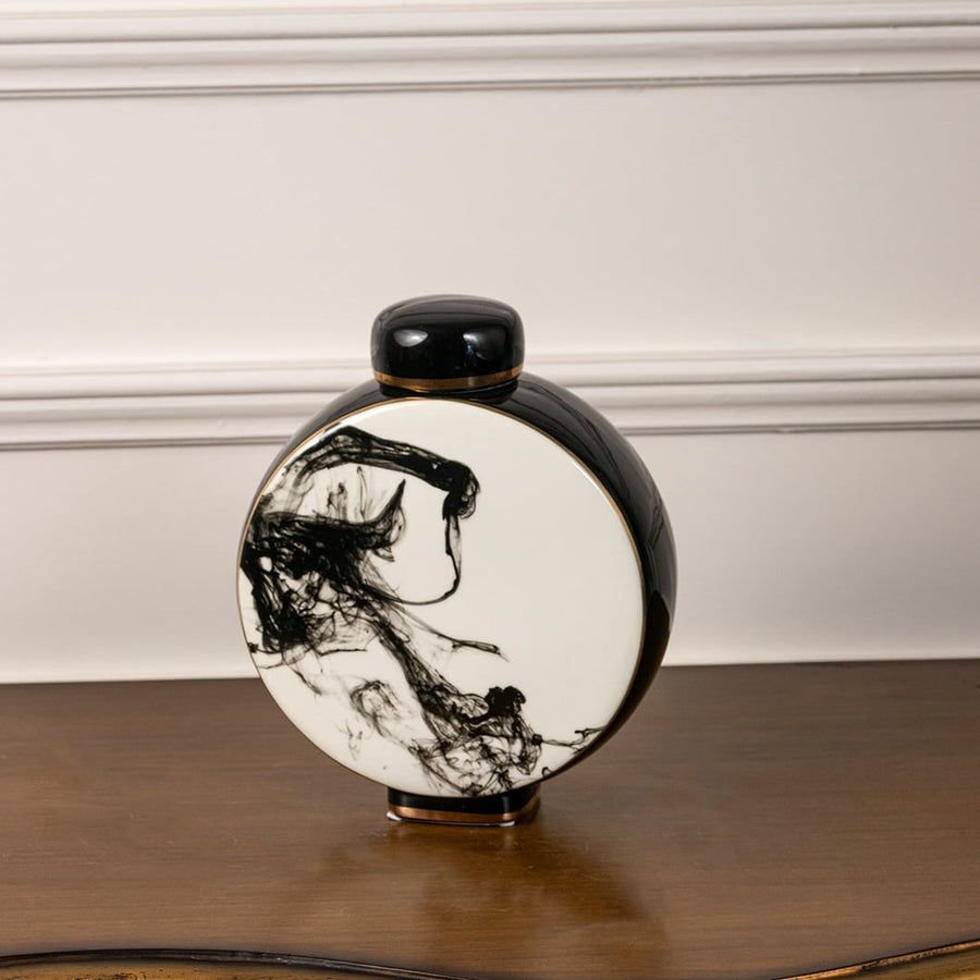 Round ceramic decorative jar with lid displayed on white background featuring black abstract brushstroke artwork for modern home decor.