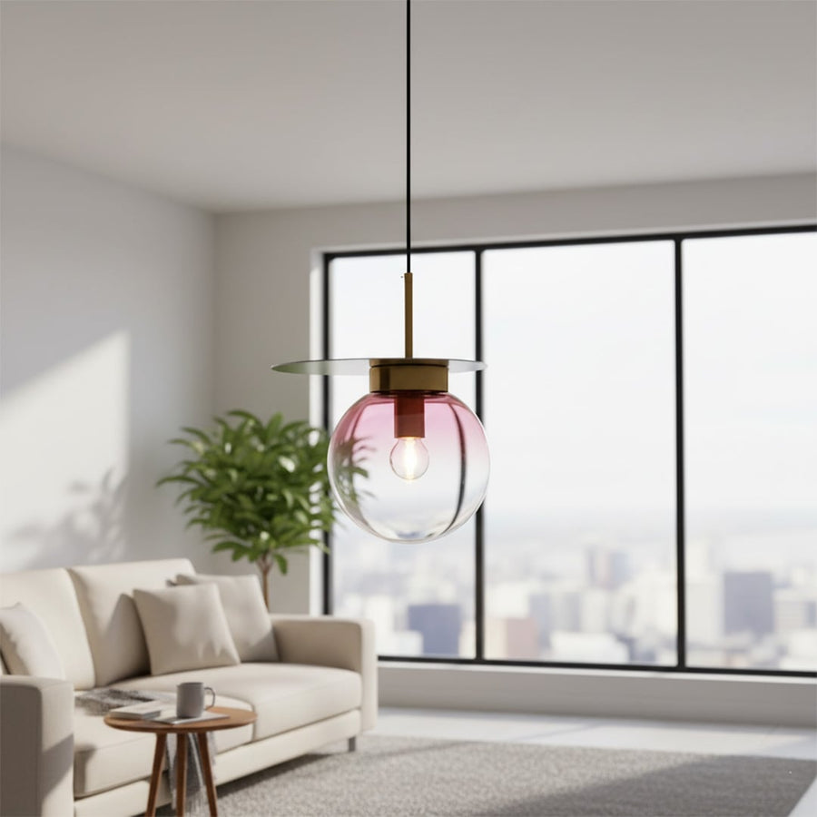 Living room styled with glass pendant light near window adding artistic color accent and airy modern interior Decor ambience.
