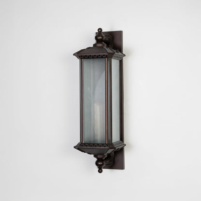 Vintage bronze wall lantern with frosted glass shade displayed off on plain white background.