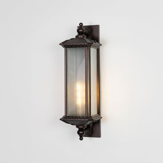 Vintage black outdoor wall light on white background with ribbed glass shade for classic patio decor.