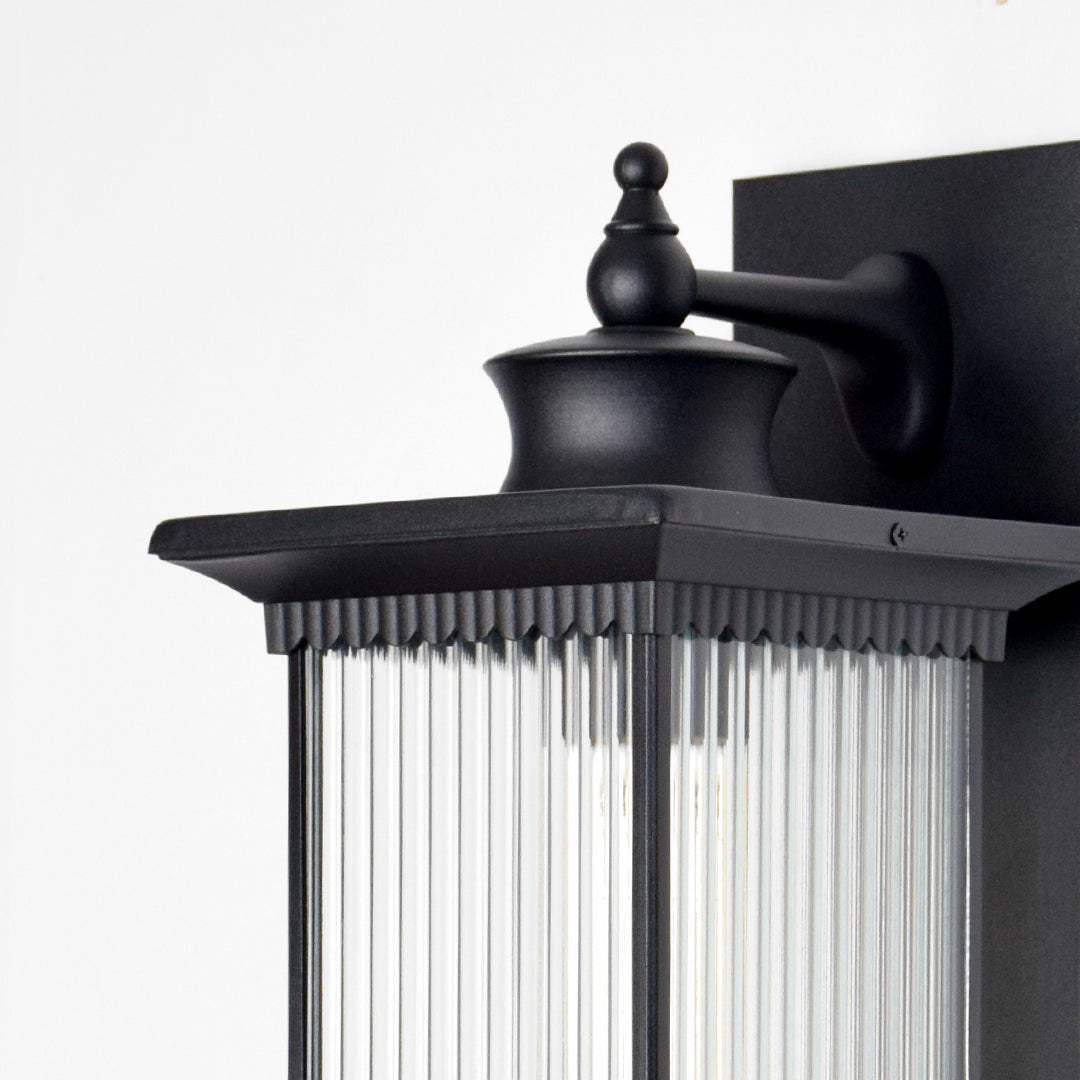 Black aluminum outdoor wall light closeup image showing the premium matte finish and linear fluted glass shade details.