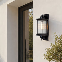 Modern black metal outdoor wall light for porch entrance garden and exterior walls with elegant warm ambient lighting.