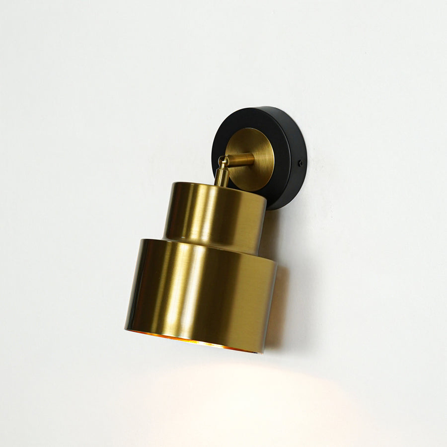 Gold cylindrical wall light with black mount modern wall lamp for bedroom living room stylish decor lighting.