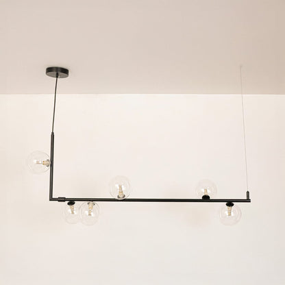Black linear chandelier with clear glass globes displayed on a white background with lights off showing clean form.