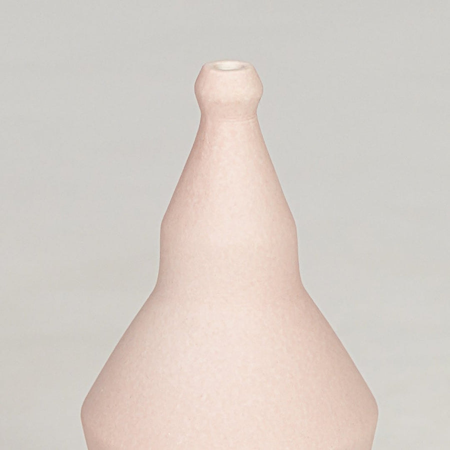 Pink ceramic decorative vase closeup with smooth finish modern flower vase for shelf console home decor styling.