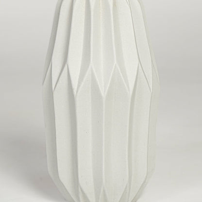 Close view of white ceramic flower vase featuring vertical sculpted pattern and smooth matte finish.