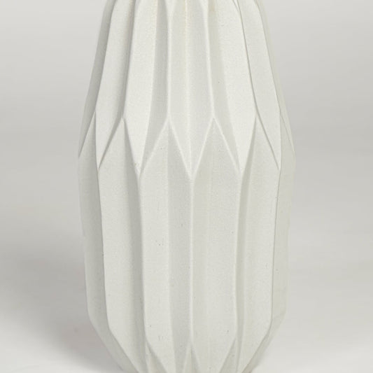 Close view of white ceramic flower vase featuring vertical sculpted pattern and smooth matte finish.