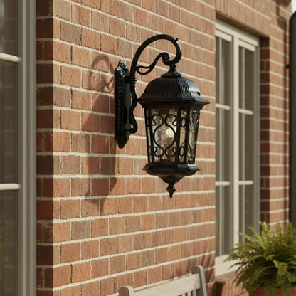 Outdoor wall lantern mounted on a brick exterior wall creating elegant ambient lighting for home facade entryway and porch decor.