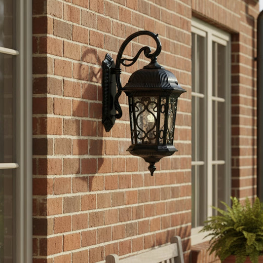 Outdoor wall lantern mounted on a brick exterior wall creating elegant ambient lighting for home facade entryway and porch decor.