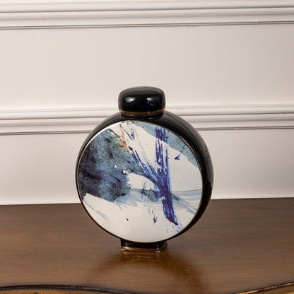 Round ceramic decorative jar displayed on white background featuring blue abstract art pattern for contemporary statement home decor.