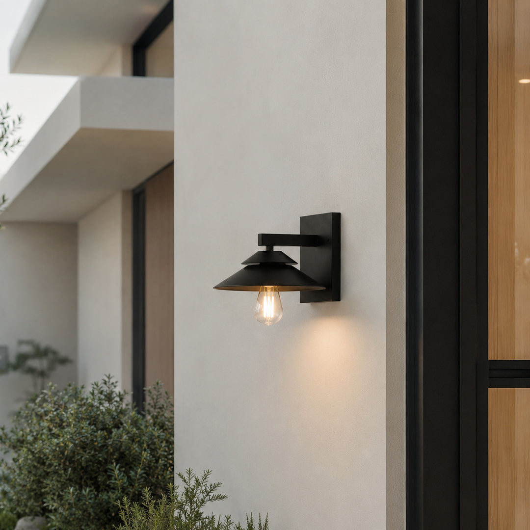 Black metal outdoor wall light lifestyle image with exposed bulb for modern exterior entryway decor.