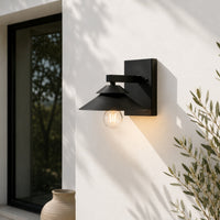 Modern black metal LED outdoor wall light for porch entrance balcony and exterior walls with warm ambient lighting.