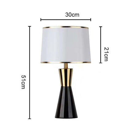 White shade black and gold tapered table lamp with size 63cm height and 30cm width on white background for modern stylish décor.