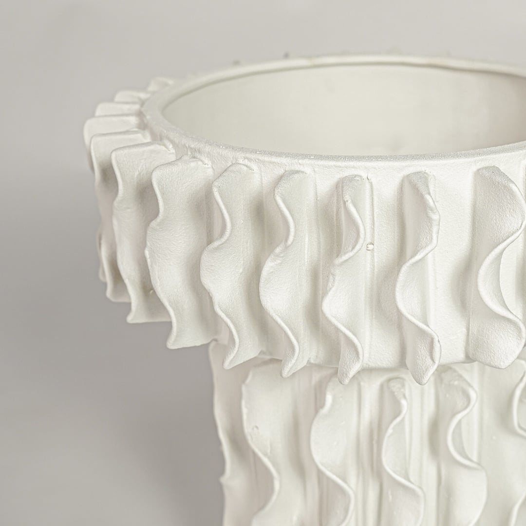 Detailed closeup of white ceramic frilled large vase showcasing layered ruffled edges and refined texture.