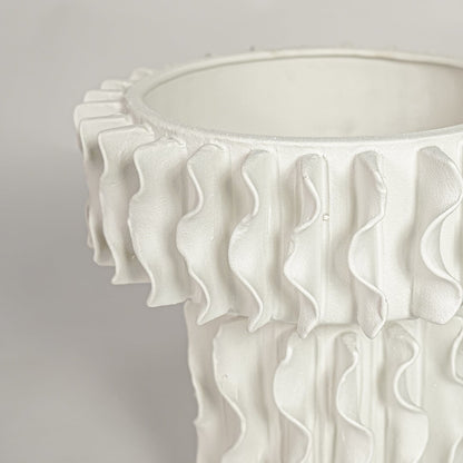 Detailed closeup of white ceramic frilled large vase showcasing layered ruffled edges and refined texture.