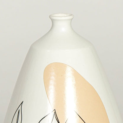 Close up view white ceramic art vase showing abstract face line drawing glossy finish decorative ceramic accent.