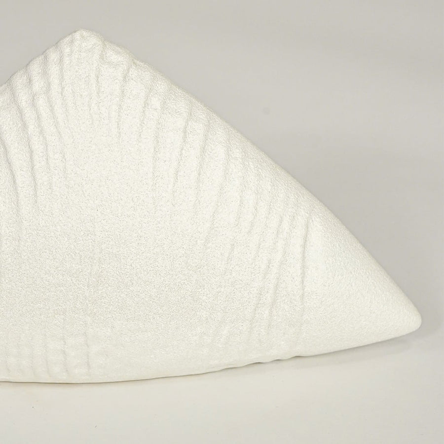 Close view of white ceramic decor sculpture showing textured surface finish and curved sculptural form.