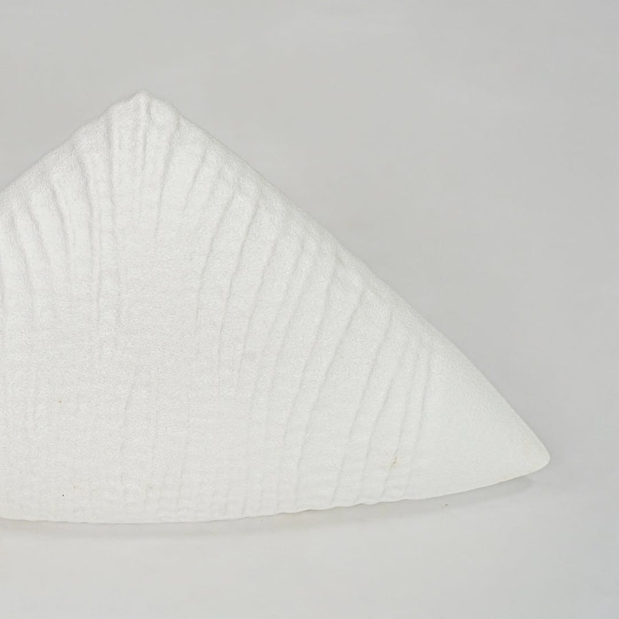 Closeup white textured ceramic decor piece surface detail modern decorative object for table shelf console decor.