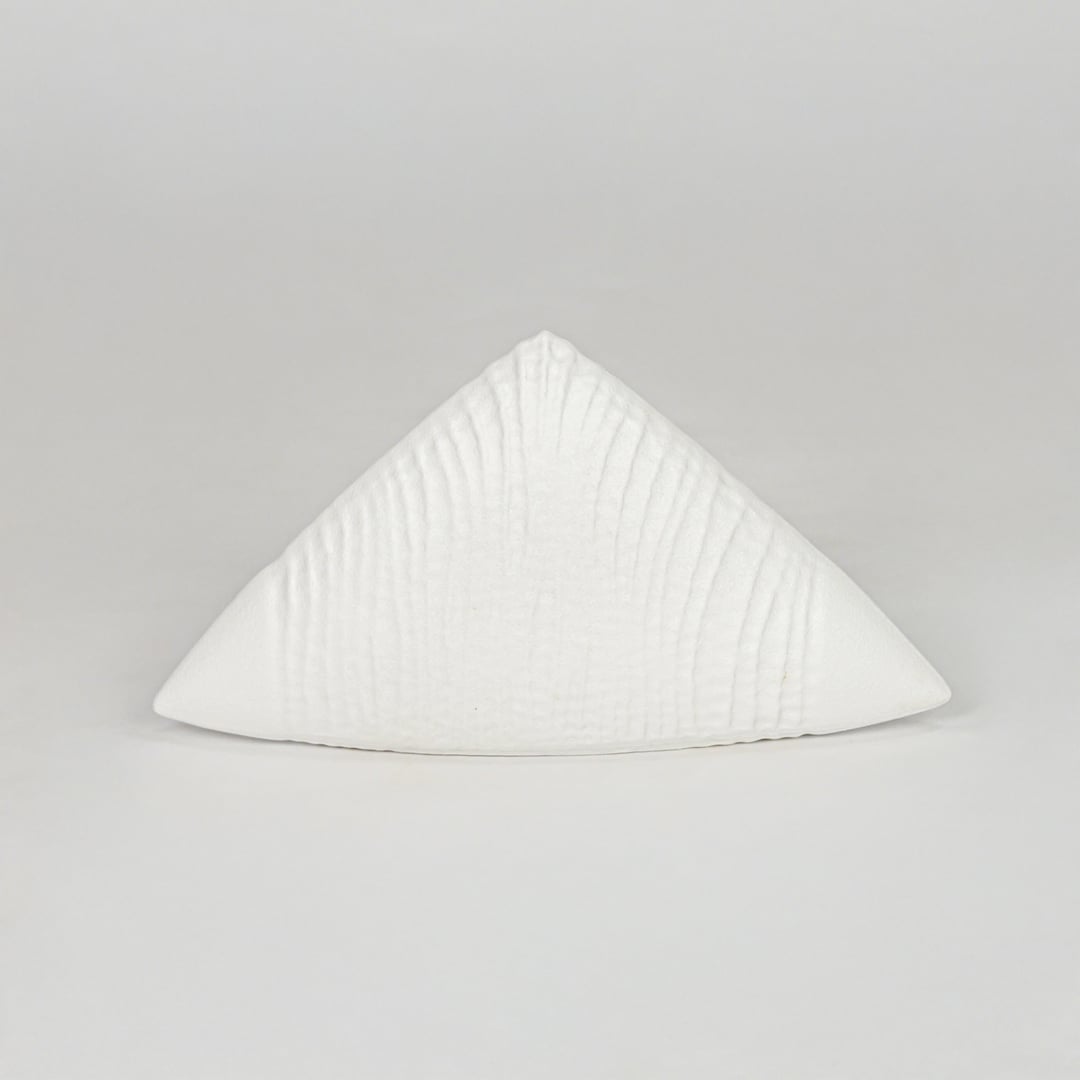 Modern white decorative ceramic showpiece isolated clean background stylish home decor accent piece.