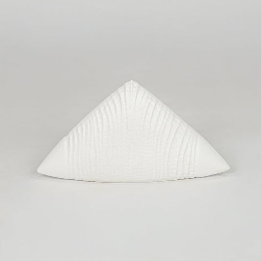 Modern white decorative ceramic showpiece isolated clean background stylish home decor accent piece.
