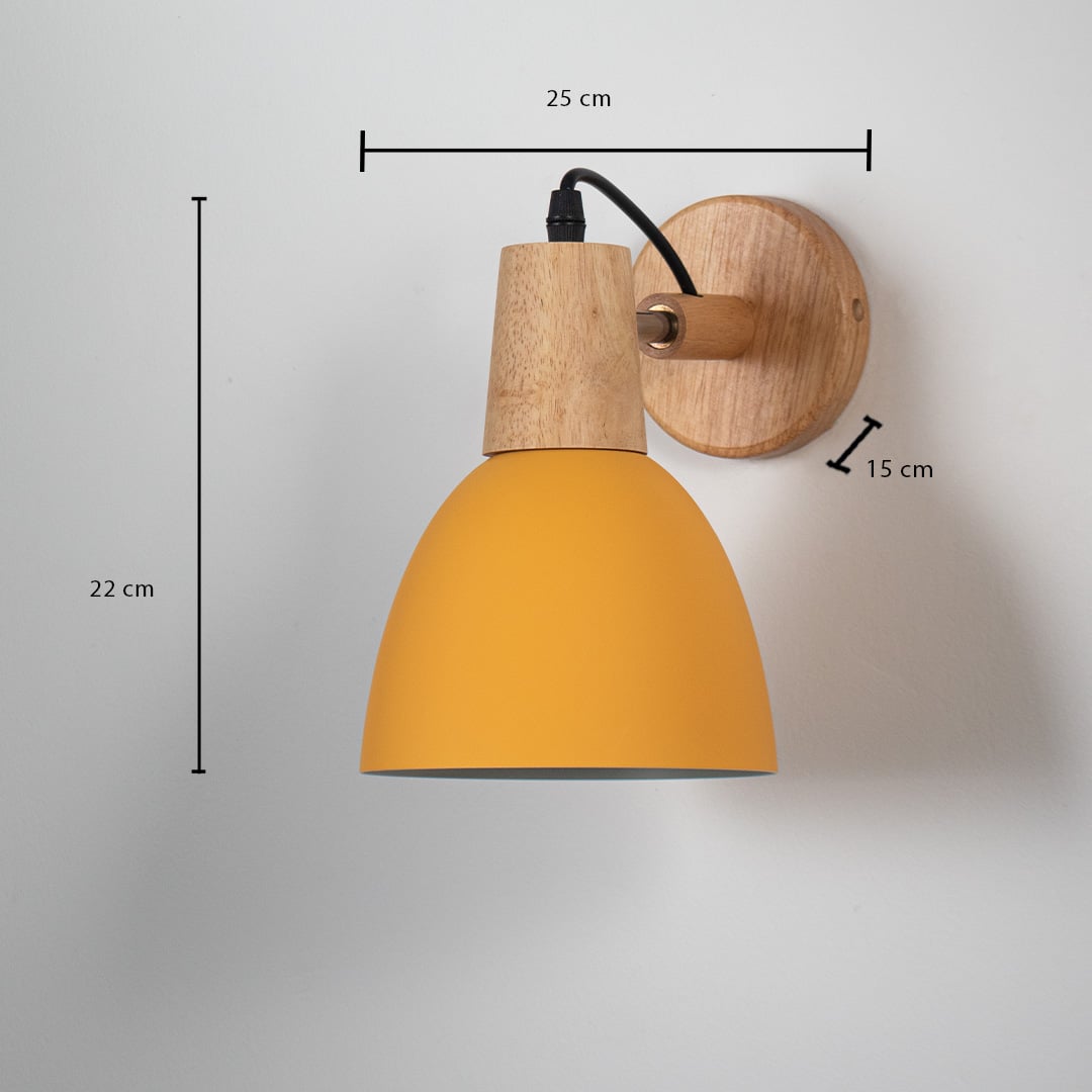 Wall lamp with matte mustard yellow shade wooden base and black cord shown with size 22 cm height 25 cm width and 15 cm depth.