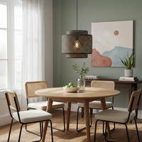 Brown woven rattan pendant light above dining table creating cozy ambiance with rustic elegance.