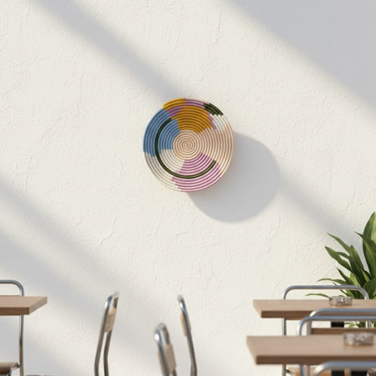 Handcrafted round wall decor with multicolor pattern mounted above dining table adding artistic charm and vibrant warmth to modern interior.
