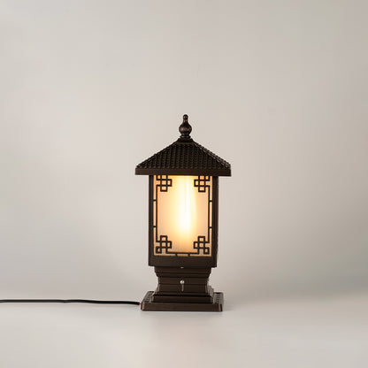 Vintage black outdoor gate light with warm glowing glass panels for elegant exterior decor use.