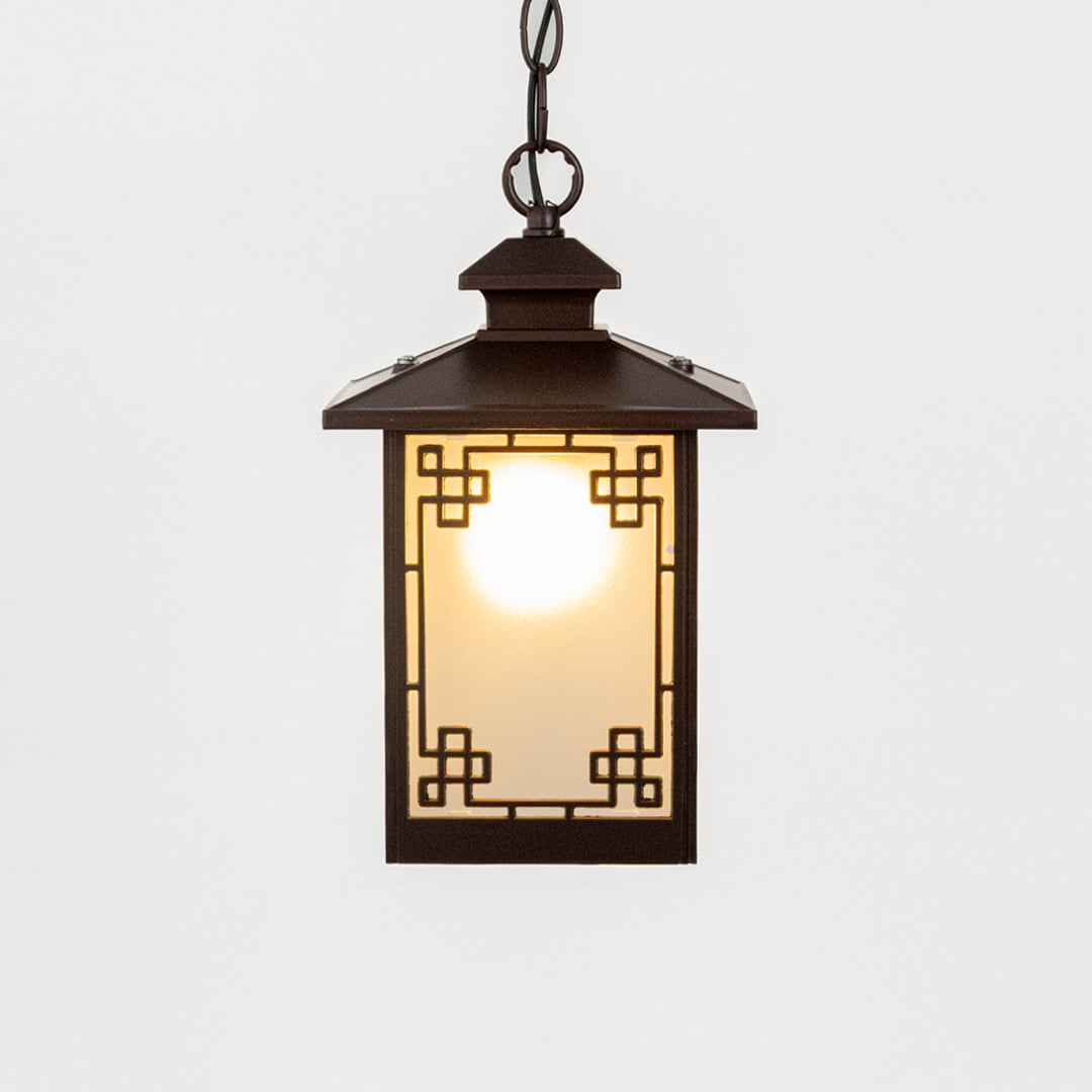 A classic rectangular hanging lantern light turned on displayed against a white background highlighting its frosted glass panels and geometric metal frame with warm illumination.