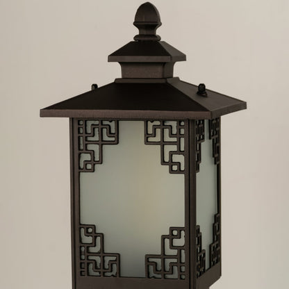 A closeup view of the outdoor bollard light highlighting the intricate geometric cutout design and frosted glass panel details that enhance its classic outdoor aesthetic.