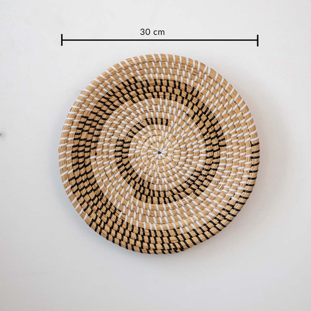Handwoven round wall basket in natural and black fiber showing 40 cm diameter suitable for statement interior wall decor placement.