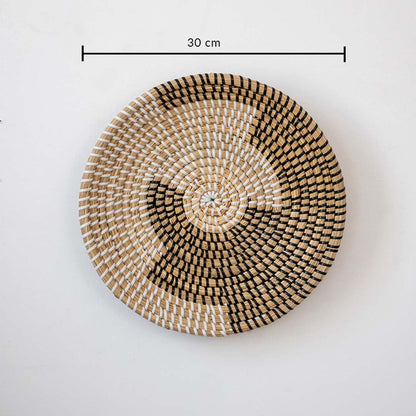 Decorative round wall basket with abstract woven pattern in natural tones showing 30 cm diameter for layered wall decor.