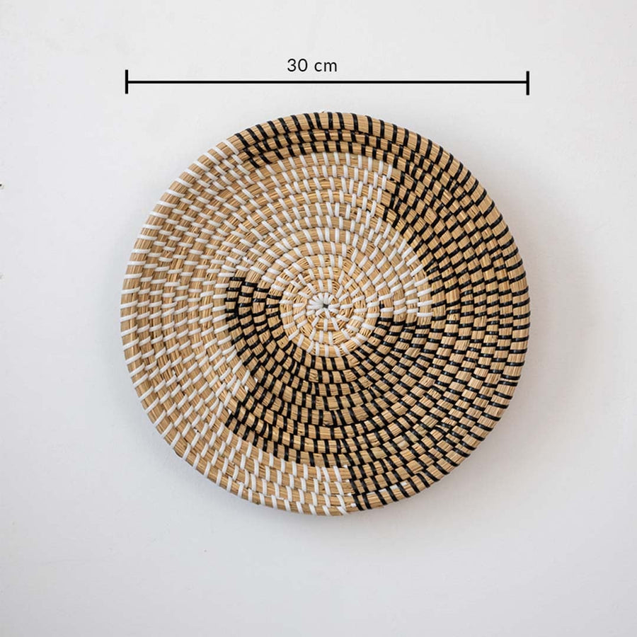Decorative round wall basket with abstract woven pattern in natural tones showing 30 cm diameter for layered wall decor.