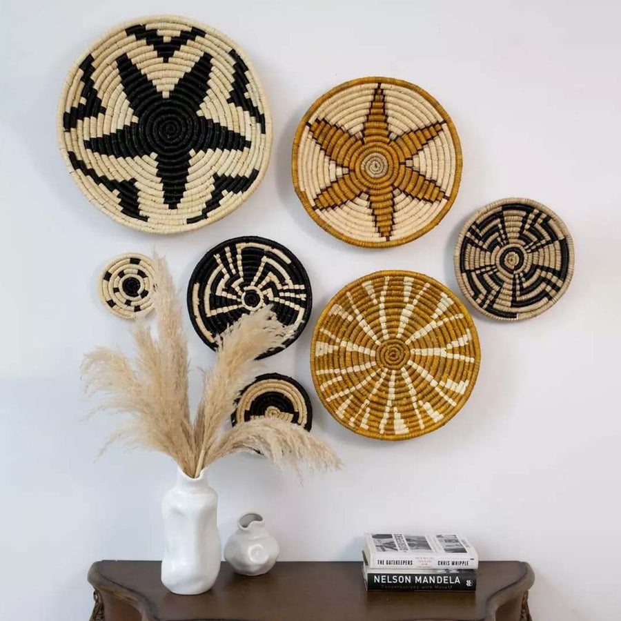 Decorative handwoven wall baskets with geometric tribal designs styled above console table for rustic decor.