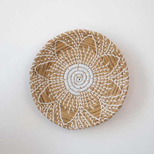 Natural woven decorative wall basket with floral pattern for contemporary wall styling and modern home decor.