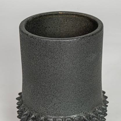 Black ceramic planter vase closeup with textured finish modern decorative pot for shelf console home decor styling.