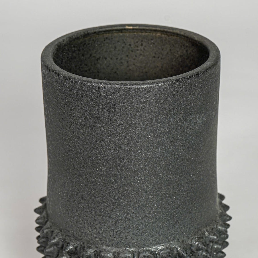 Black ceramic planter vase closeup with textured finish modern decorative pot for shelf console home decor styling.