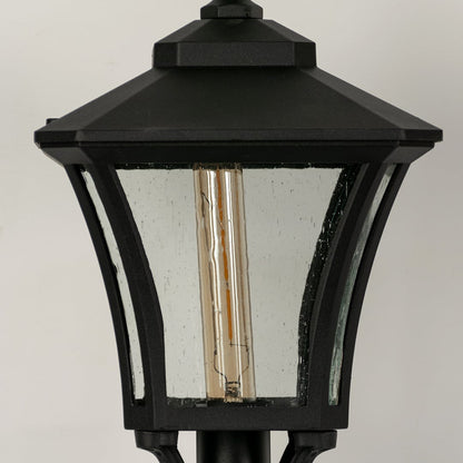Closeup of black outdoor gate light with textured glass panels for luxury exterior decor styling use.