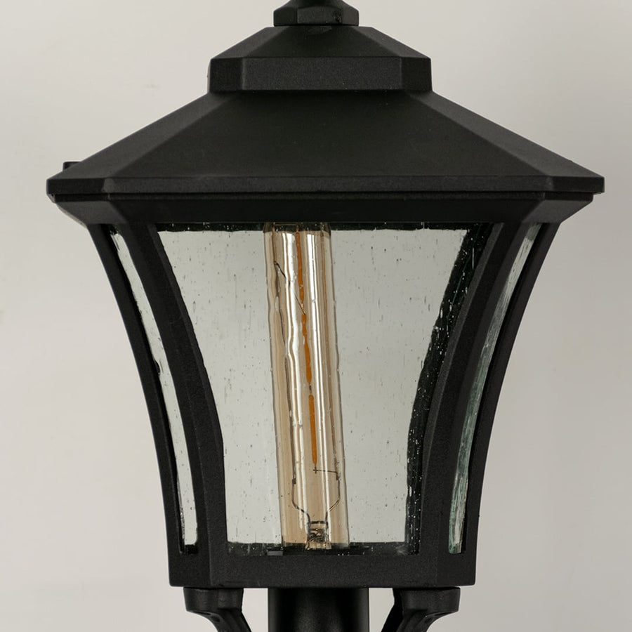 Closeup of black outdoor gate light with textured glass panels for luxury exterior decor styling use.
