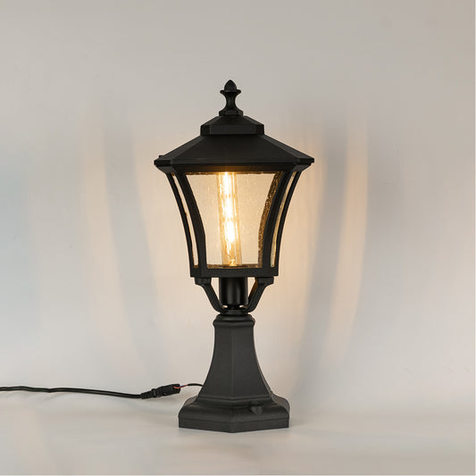 Vintage black outdoor gate light with warm glowing bulb for elegant exterior decor styling use.