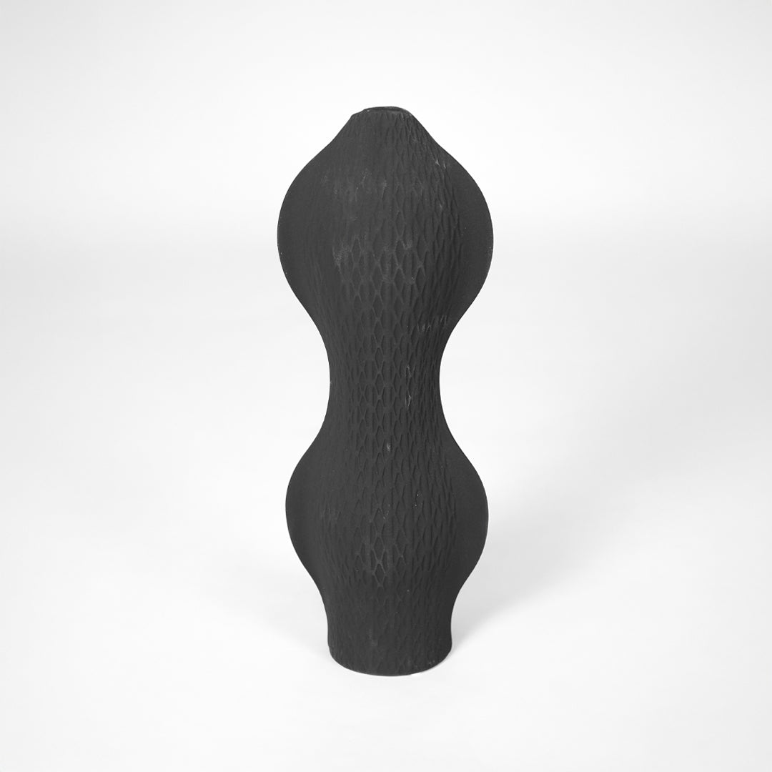 White background image of black ceramic textured vase for modern interior decor styling with matte finish.