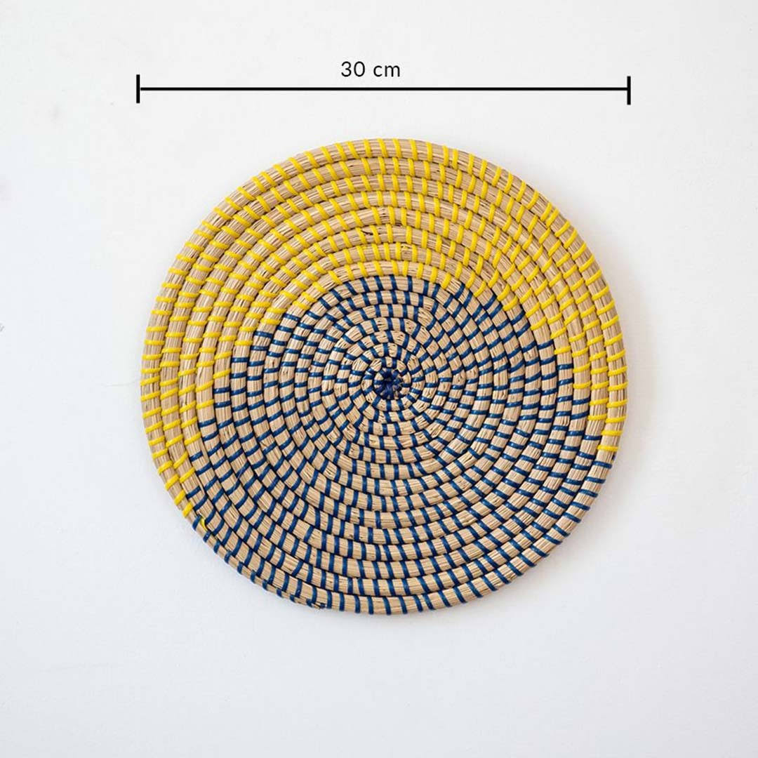Handwoven seagrass round wall basket decor in yellow and charcoal with modern woven pattern and size guide on white.