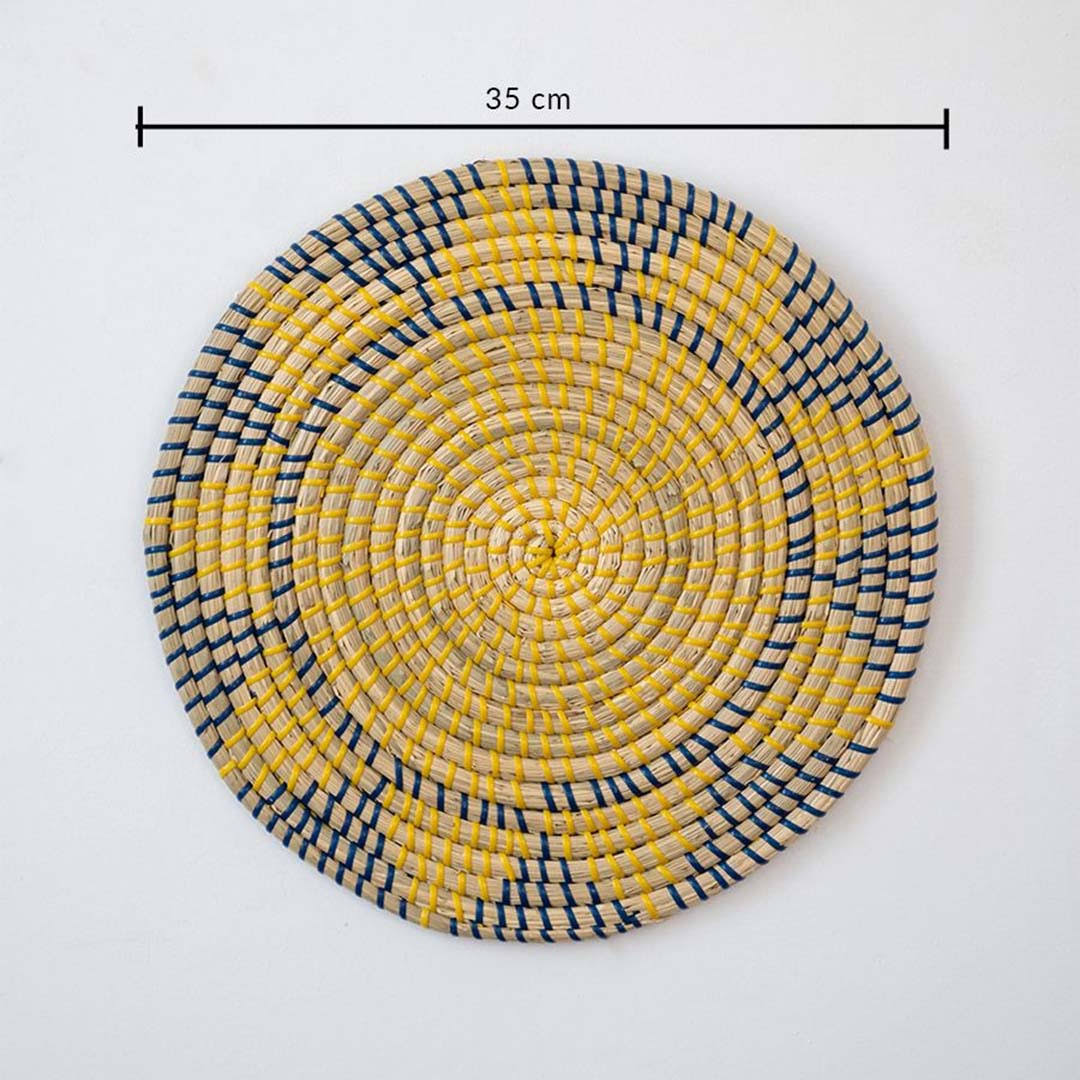 Handwoven seagrass round wall basket decor in yellow and charcoal with geometric woven pattern and size guide on white.