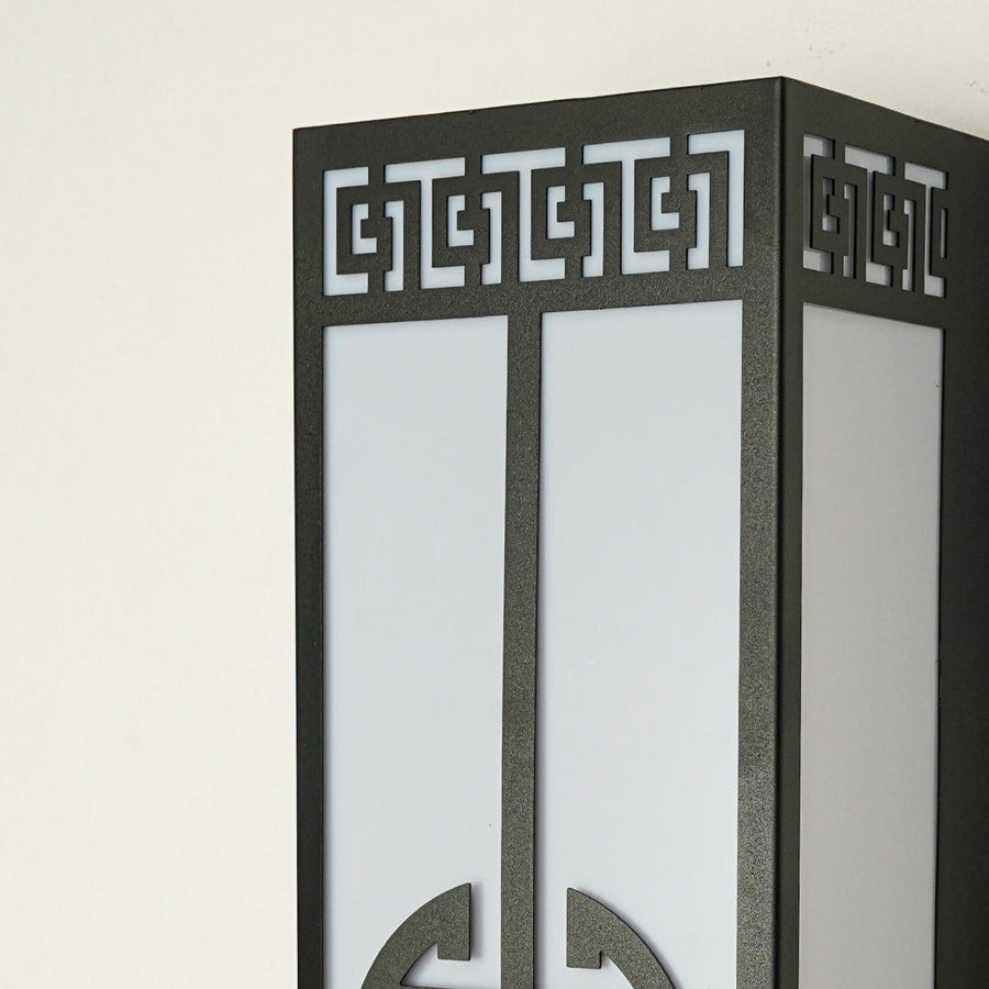 Close view of outdoor wall light with intricate geometric metal detailing showcasing premium exterior lighting craftsmanship.