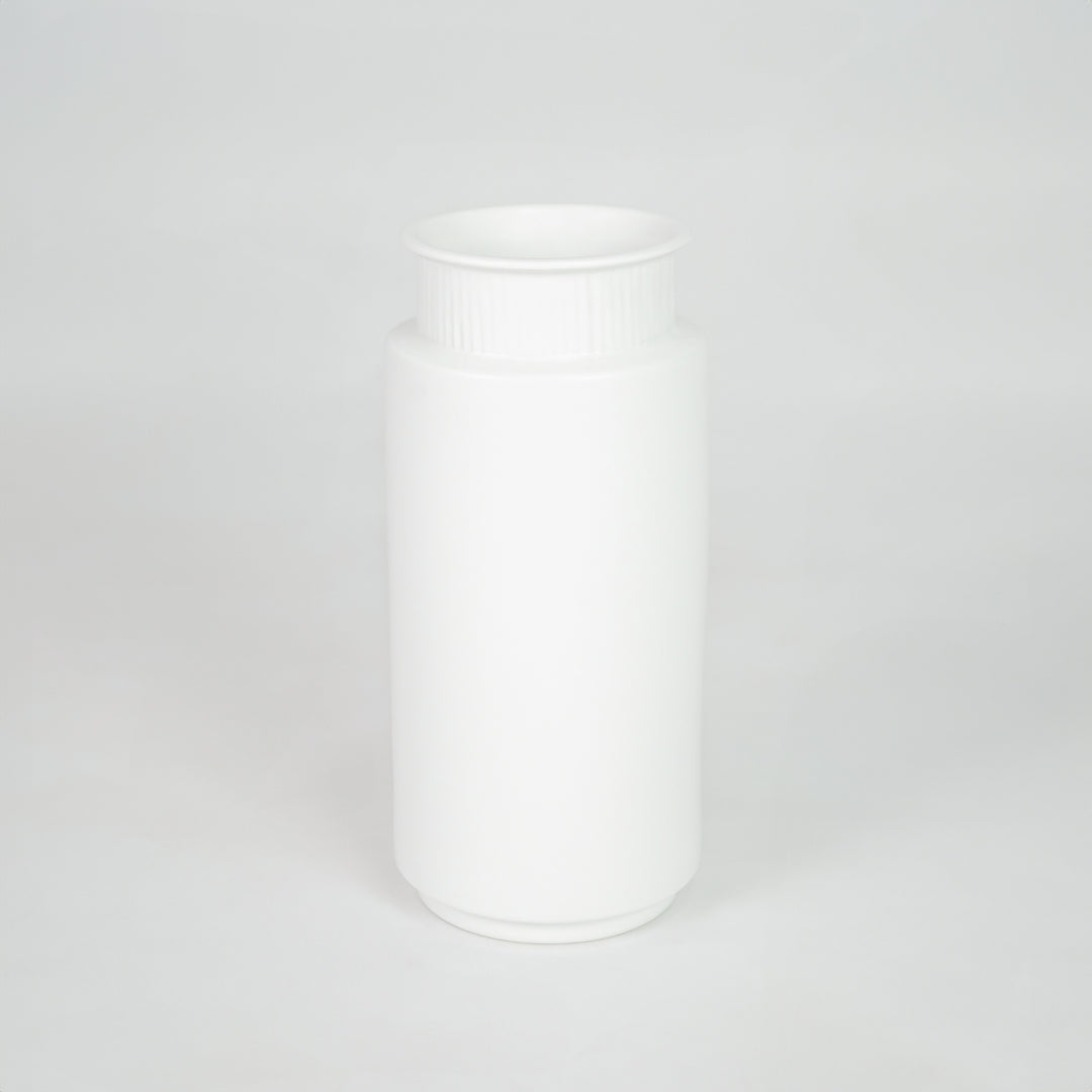 White ceramic storage jar for modern kitchen shelf placement and minimalist indoor decor styling accent piece.