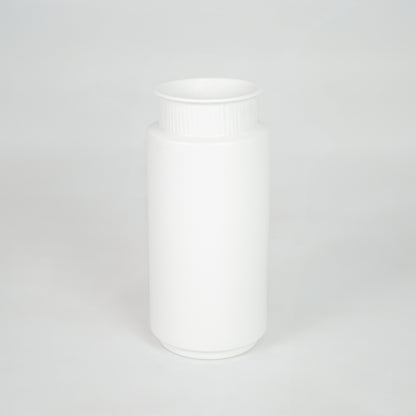 White ceramic storage jar for modern kitchen shelf placement and minimalist indoor decor styling accent piece.